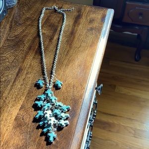 Teal cross necklace and earrings.